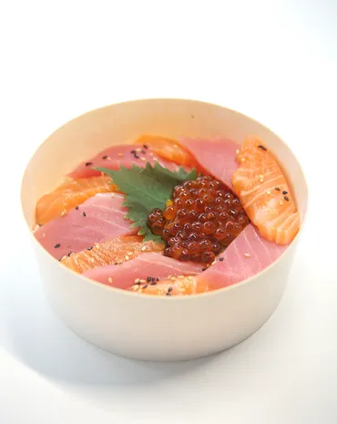 Chirashi bowl of salmon and tuna sashimi topped with ikura